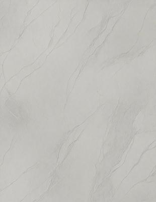 The primary subject of the image is a white marble wall with a pattern of swirls and waves. The setting is a room with a white background, and the visual style is a close-up of the marble wall. The colors and mood of the image are predominantly white, giving it a clean and elegant appearance.