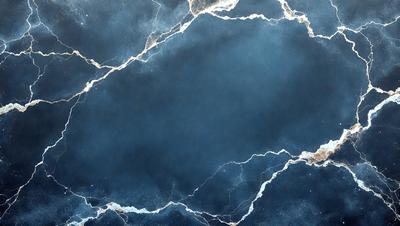 The primary subject of the image is a blue marble wall with white veins. The setting is a dark room, and the visual style is a photo. The dominant colors are blue and white, creating a calm and serene atmosphere.