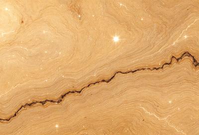 The primary subject of the image is a marble countertop with a crack in it. The setting is a kitchen, and the visual style is a close-up of the marble countertop. The colors and mood of the image are predominantly brown, giving it a natural and earthy appearance.