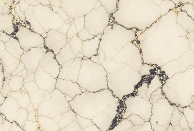 The image features a white marble surface with a gold-colored vein running through it. The marble has a rough texture, giving it a unique and natural appearance. The gold vein adds a touch of luxury and sophistication to the overall design. The combination of white and gold creates a visually appealing and elegant aesthetic.