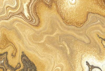 The primary subject of the image is a close-up of a gold and brown swirling pattern, which appears to be a marbled or textured surface. The setting is a room with a wall, and the visual style is a close-up of the pattern, showcasing its intricate details. The colors and mood of the image are warm and inviting, with the gold and brown tones creating a sense of luxury and sophistication.