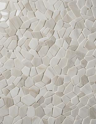 The primary subject of the image is a white tile wall with a pattern of white and grey tiles. The setting is a room with a white tile wall as the main focus. The visual style is a close-up of the tile wall, showcasing the intricate pattern of the tiles. The colors and mood of the image are predominantly white and grey, giving it a clean and minimalist appearance.