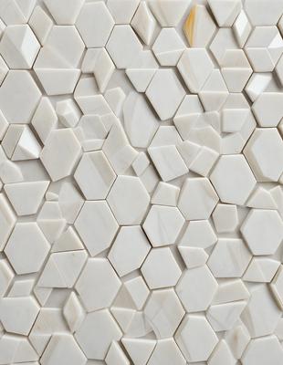 The primary subject of the image is a white tile wall with a pattern of white and grey tiles. The setting is a room with a white tile wall as the main focus. The visual style is a close-up of the tile wall, showcasing the intricate pattern of the tiles. The colors and mood of the image are predominantly white and grey, giving it a clean and minimalist appearance.