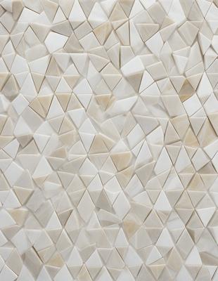 The primary subject of the image is a white tile wall with a pattern of triangles. The setting is a room with a white tile floor. The visual style is a close-up of the tile wall, showcasing the intricate pattern. The dominant colors are white and grey, creating a clean and minimalist atmosphere.