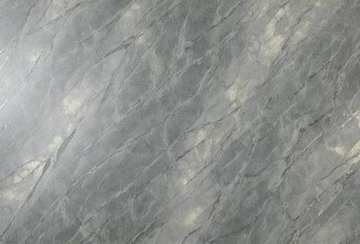 The primary subject of the image is a marble wall with a patterned texture. The setting is a room with a gray marble wall as the background. The visual style is a close-up of the marble wall, showcasing its unique texture. The colors and mood of the image are predominantly gray, giving it a calm and sophisticated atmosphere.