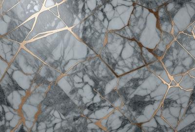 The primary subject of the image is a marble countertop with a gold-colored design. The setting is a kitchen, and the visual style is a close-up of the marble countertop. The colors and mood of the image are predominantly neutral, with the gold accents adding a touch of warmth and sophistication.
