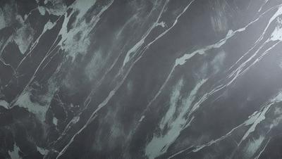The primary subject of the image is a gray marble wall with a pattern of swirls and waves. The setting is a room with a gray background, and the visual style is a close-up of the marble wall. The colors and mood of the image are predominantly gray, giving it a calm and sophisticated atmosphere.