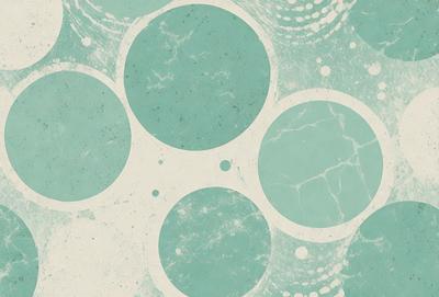 The primary subject of the image is a pattern of circles on a blue background. The circles are arranged in a circular pattern, and they are of various sizes. The setting is a blue wall, and the visual style appears to be a combination of a photo and a digital art or illustration. The dominant colors are blue and white, creating a calm and soothing atmosphere.