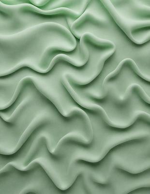 The primary subject of the image is a close-up of a green, textured wall. The setting is a room with a green wall, and the visual style is a photo. The dominant colors are green, and the overall atmosphere is smooth and curved.