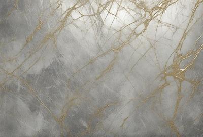 The primary subject of the image is a marble wall with a patterned texture. The setting is a room with a grey background. The visual style is a photo of the marble wall. The dominant colors are grey and gold, creating a warm and elegant atmosphere.