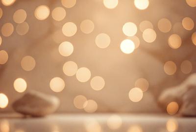 The primary subject of the image is a white wall with a pattern of lights on it. The setting is a room with a white surface, and the visual style appears to be a photo. The dominant colors are white and gold, creating a warm and inviting atmosphere.