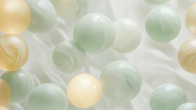 The primary subject of the image is a group of green and white balls. The setting is a white background, which creates a clean and minimalist appearance. The visual style is a close-up of the balls, showcasing their colors and textures. The dominant colors are green and white, giving the image a calm and soothing atmosphere.