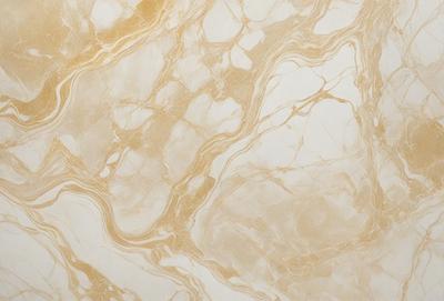 The primary subject of the image is a marble wall with a gold and white color scheme. The setting is a room with a patterned wallpaper, which adds a unique touch to the space. The visual style is a combination of a photo and a pattern, creating a distinctive and elegant appearance. The colors and mood of the image are warm and inviting, with the gold and white tones evoking a sense of luxury and sophistication.