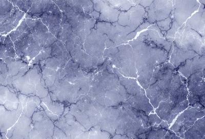 The primary subject of the image is a marble wall with a blue and white color scheme. The setting is a room with a blue and white marble wall, which serves as the background. The visual style of the image is a close-up of the marble wall, showcasing its intricate patterns and textures. The colors and mood of the image are predominantly blue and white, creating a serene and elegant atmosphere.