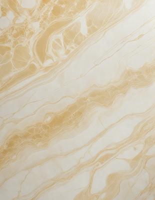 The primary subject of the image is a marble wall with a gold-colored pattern. The setting is a room with a white background. The visual style is a close-up of the marble wall, showcasing its intricate design. The colors and mood of the image are warm and elegant, with the gold and white colors creating a luxurious and sophisticated atmosphere.