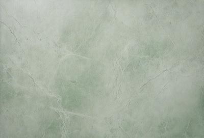 The image features a large, white, and green marble wall. The marble wall is textured and has a greenish hue. The wall appears to be a part of a building, possibly a museum or a historical site. The overall atmosphere of the image is elegant and sophisticated, with the marble wall serving as a striking focal point.