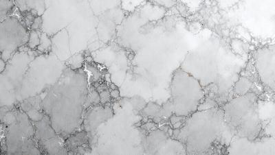 The image features a marble surface with a white and grey color scheme. The marble has a patterned texture, giving it a unique and elegant appearance. The primary subject of the image is the marble surface, which serves as the main object, scene, or focus of the image. The setting or background is a white wall, which provides a clean and minimalist backdrop for the marble surface. The visual style of the image is a close-up of the marble, showcasing its intricate pattern and texture. The