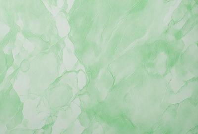 The primary subject of the image is a green marble wall. The setting is a room with a green marble wall as the main focus. The visual style is a drawing or painting, with the artist using a green color palette to create a serene and calming atmosphere.
