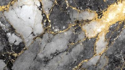 The primary subject of the image is a marble wall with a gold-colored pattern. The setting is a room with a stone wall, and the visual style is a close-up of the marble wall. The colors and mood of the image are predominantly dark, with the gold pattern providing a contrasting element.