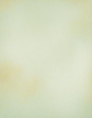 The primary subject of the image is a white wall with a yellowish tint. The setting is a room with a yellowish tinted wall. The visual style is a photo, and the colors and mood are predominantly yellowish with a slightly warm and inviting atmosphere.