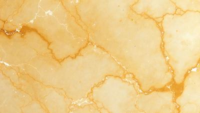The primary subject of the image is a marble wall with a yellowish hue. The setting is a room with a yellowish marble wall, which serves as the background. The visual style is a close-up of the marble wall, showcasing its texture and color. The dominant colors are yellow and brown, creating a warm and natural atmosphere.