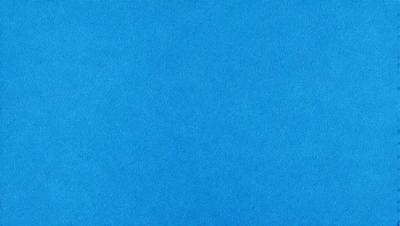 The primary subject of the image is a large, blue surface. The setting is a clear, blue sky, and the visual style is a photo. The colors and mood of the image are predominantly blue, creating a calm and serene atmosphere.