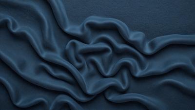 The primary subject of the image is a blue fabric with a wavy pattern. The setting is a blue background, and the visual style appears to be a photo. The dominant colors are blue and purple, creating a calm and soothing atmosphere.
