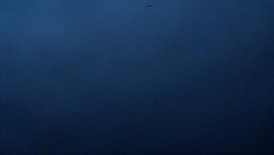 The primary subject of the image is the sky, which is a deep shade of blue. The setting is a cloudy day, with a few clouds visible in the sky. The visual style is a photo, capturing the beauty of the cloudy sky. The colors and mood of the image are serene and peaceful, as the sky is void of any distractions or objects.