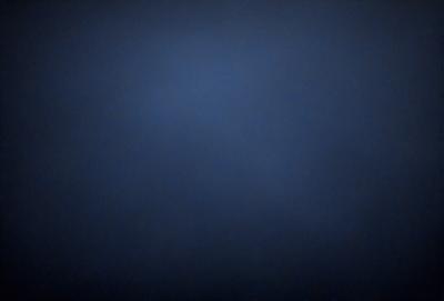 The primary subject of the image is a blue sky with no clouds. The setting is a dark, empty sky, and the visual style is a photo. The colors and mood of the image are predominantly dark and moody, with the blue sky being the main focus.