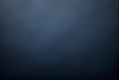 The primary subject of the image is a dark blue sky with no clouds. The setting is a vast, open space with no visible landmarks or objects. The visual style is a simple, monochromatic representation of the sky. The colors and mood convey a sense of calmness and tranquility.