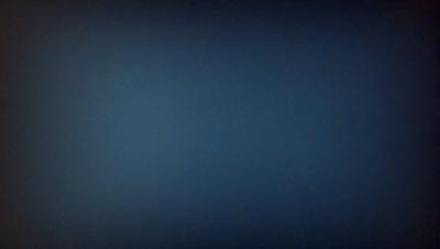 The primary subject of the image is a blue sky with no clouds. The setting is a dark blue background, which creates a contrast with the bright blue sky. The visual style is a simple, clean, and minimalist representation of the sky. The colors and mood of the image are predominantly dark and moody, with the blue sky being the only bright spot in the scene.