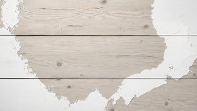 The primary subject of the image is a wooden floor with a white surface. The setting is a room with a wooden floor, and the visual style is a photo. The colors and mood of the image are predominantly white, giving it a clean and minimalist appearance.