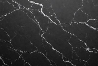 The primary subject of the image is a close-up of a marble wall with a black background. The setting is a room with a black marble wall, and the visual style is a photo. The colors and mood of the image are predominantly black, giving it a sleek and modern appearance.