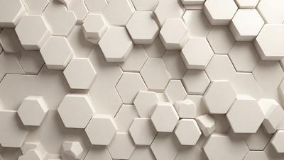 The primary subject of the image is a white wall with a pattern of hexagonal shapes. The setting is a room with a white tile wall, and the visual style is a close-up of the wall. The dominant colors are white, and the overall atmosphere is clean and minimalistic.