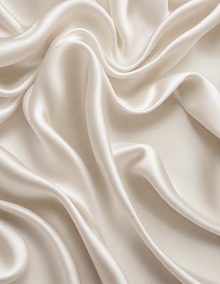 The primary subject of the image is a white fabric, possibly a sheet or a curtain, with a wrinkled texture. The setting is a white background, which provides a clean and minimalist appearance. The visual style is a close-up of the fabric, showcasing its texture and details. The colors and mood of the image are predominantly white, giving it a clean and serene atmosphere.