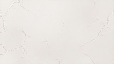 The primary subject of the image is a white wall with a cracked texture. The setting is a room with a white background. The visual style is a close-up of the wall, showcasing the cracked texture. The colors and mood of the image are predominantly white, giving it a clean and minimalist appearance.