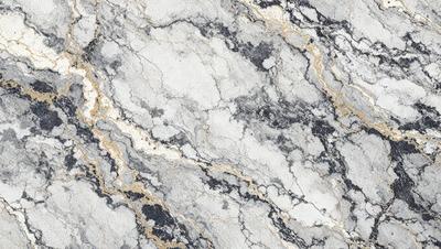The primary subject of the image is a marble surface with a gold-colored border. The setting is a marble countertop, and the visual style is a close-up of the marble surface. The colors and mood of the image are predominantly white and gold, giving it a luxurious and elegant appearance.