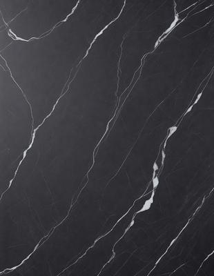 The primary subject of the image is a black marble countertop. The setting is a kitchen, with the countertop being the main focus of the scene. The visual style is a close-up of the marble countertop, showcasing its texture and details. The colors and mood of the image are predominantly dark, with the black marble countertop being the main source of contrast and visual interest.