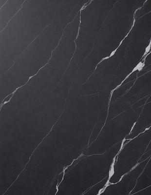 The primary subject of the image is a black marble countertop. The setting is a kitchen, with the countertop being the main focus of the scene. The visual style is a close-up of the marble countertop, showcasing its texture and pattern. The colors and mood of the image are dark and moody, with the black marble countertop being the dominant color.