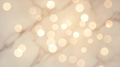 The primary subject of the image is a pattern of lights, which are bright and shining. The setting is a white marble surface, which provides a clean and elegant backdrop for the lights. The visual style of the image is a combination of photo and digital art, creating a unique and eye-catching pattern. The colors and mood of the image are predominantly warm and inviting, with the bright lights creating a sense of warmth and energy.