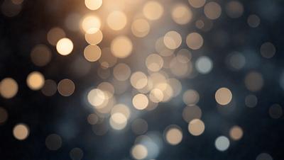 The primary subject of the image is a bright, colorful, and blurry background featuring a pattern of light and dark dots. The setting appears to be a nighttime scene, with the lights creating a visually striking and dynamic atmosphere. The visual style of the image is a combination of photo and digital art, as it captures the essence of a blurry, artistic background. The colors and mood of the image are predominantly dark and bright, with the dots creating a sense of depth and movement.