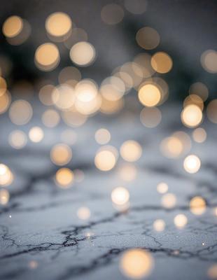 The primary subject of the image is a close-up of a light source, possibly a light bulb or a string of lights, creating a visually striking pattern of bright lights. The setting is a dark background, which contrasts with the bright lights, creating a dramatic effect. The visual style is a close-up of the light source, emphasizing the details of the light pattern. The colors and mood of the image are predominantly dark, with the bright lights creating a sense of contrast and visual interest.