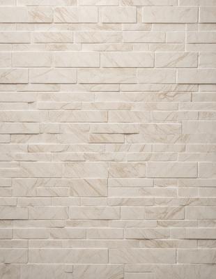 The image features a white marble wall with a patterned design. The wall is made of tiles, and the pattern is visible on the surface. The overall atmosphere of the image is clean and elegant, with the white marble wall serving as a striking backdrop.
