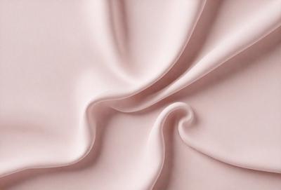 The primary subject of the image is a piece of pink fabric. The setting is a close-up view of the fabric, showcasing its texture and color. The visual style is a realistic representation of the fabric, with no indication of digital art or illustration. The colors and mood of the image are predominantly pink, creating a soft and feminine atmosphere.