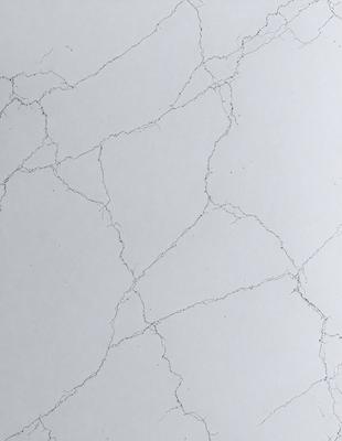 The primary subject of the image is a white wall with a pattern of cracks and lines. The setting is a room with a white surface, and the visual style appears to be a photo. The dominant colors are white and grey, creating a clean and minimalist atmosphere.