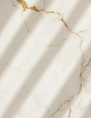 The primary subject of the image is a marble countertop with a gold-colored vein. The setting is a kitchen, and the visual style is a photo. The countertop has a white and gold color scheme, giving it a luxurious and elegant appearance.