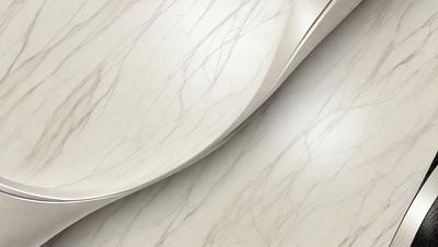 The primary subject of the image is a silver spoon, which is the main object in the scene. The spoon is placed on a marble countertop, which serves as the setting or background. The visual style of the image is a photo, capturing the spoon's reflection on the marble surface. The colors in the image are predominantly silver and white, giving the scene a clean and elegant appearance.