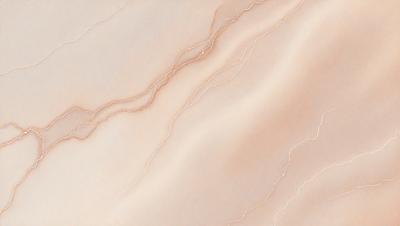 The primary subject of the image is a marble wall with a pinkish hue. The setting is a room with a marble countertop. The visual style is a close-up of the marble wall, showcasing its texture and color. The colors and mood of the image are warm and inviting, with the marble wall and countertop creating a luxurious and elegant atmosphere.