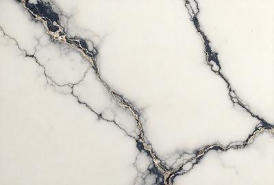 The primary subject of the image is a marble countertop with a gold-like pattern. The setting is a kitchen, and the visual style is a close-up of the marble countertop. The colors and mood of the image are predominantly white and gold, giving it a luxurious and elegant appearance.