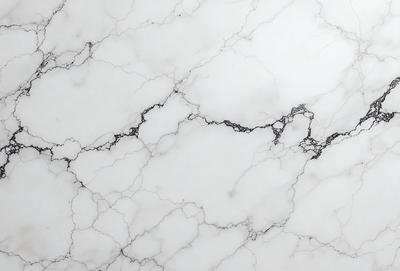 The image features a marble countertop with a white marble finish. The countertop has a patterned design, giving it a unique and elegant appearance. The marble countertop is the primary subject of the image, showcasing its beauty and texture. The setting is a kitchen or bathroom, as the countertop is typically found in these spaces. The visual style is a close-up of the marble countertop, highlighting its intricate details and design. The colors and mood of the image are predominantly white
